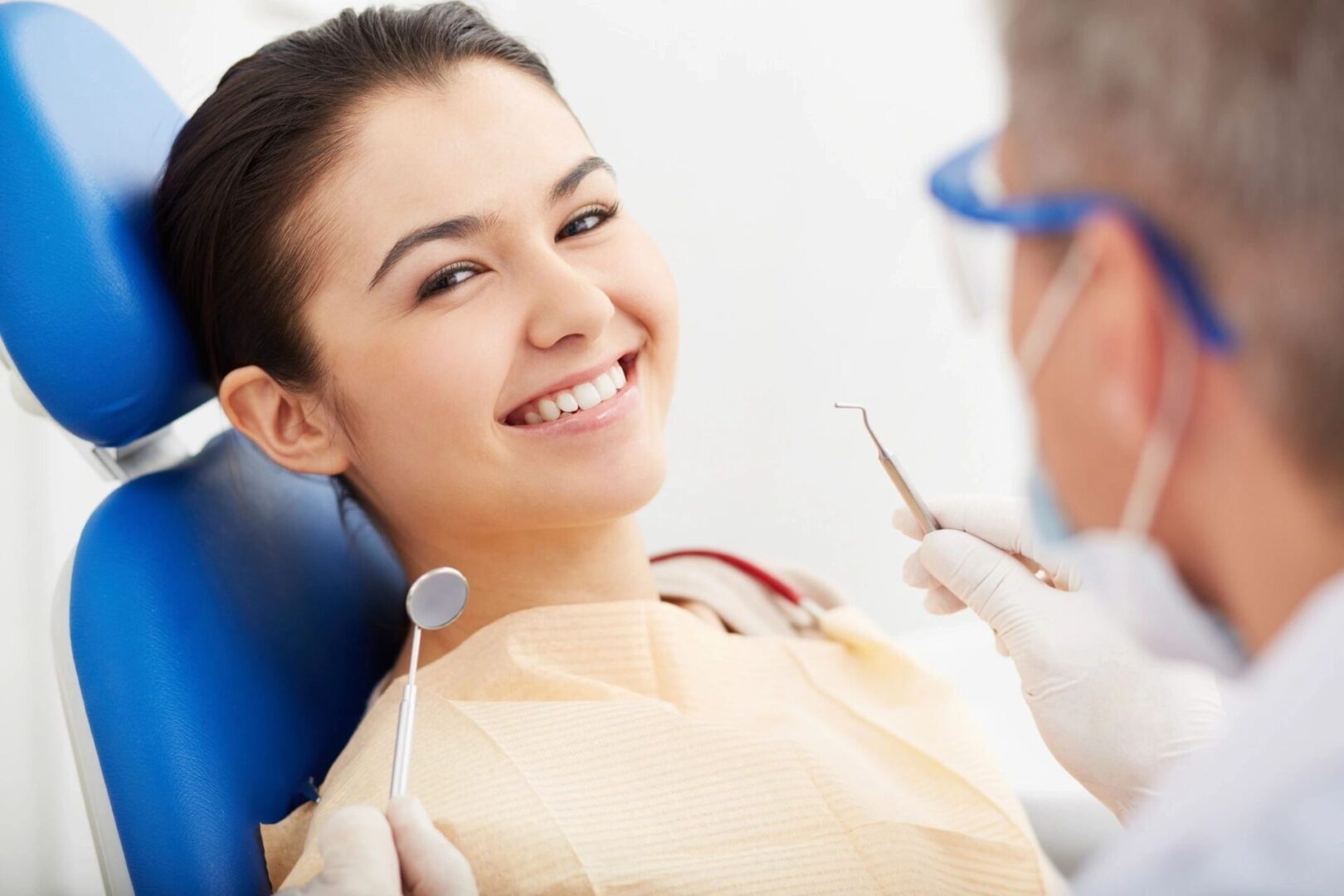 Smiling patient in a dental chair.