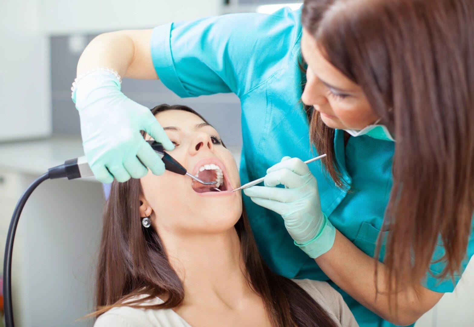 Dentist examining patient's mouth and teeth.