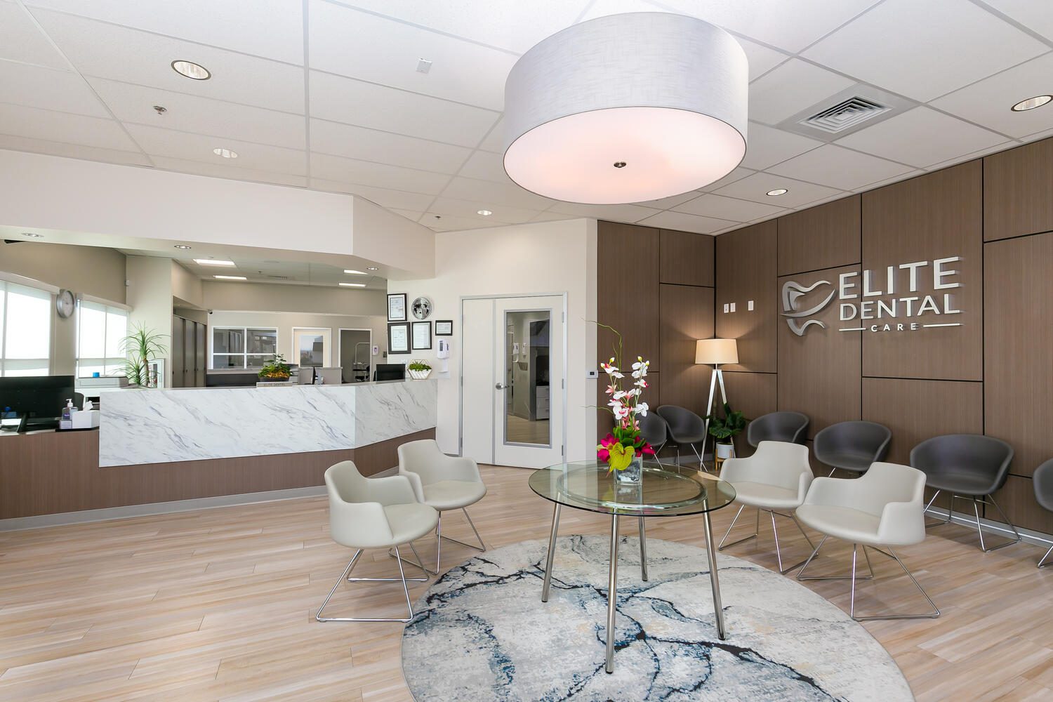 Modern dental office waiting area with seating.