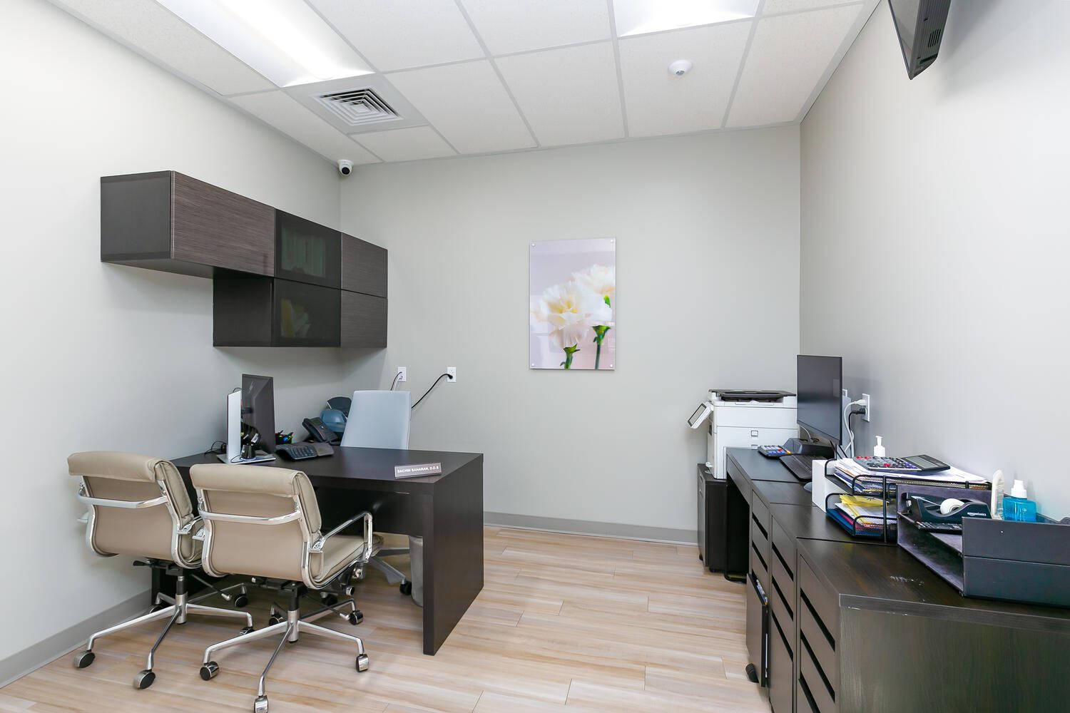 Modern office with two chairs and equipment.